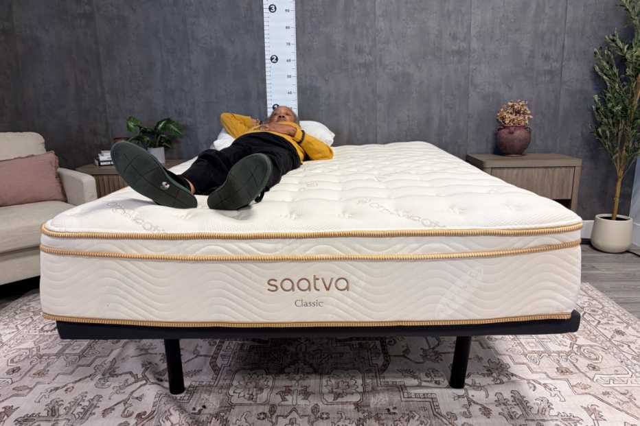 A woman lying on her back on the Saatva Classic mattress.
