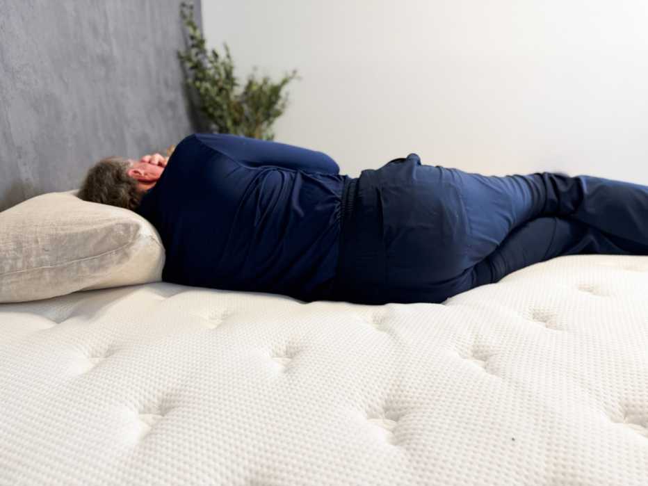 A man lying on his side on the Brooklyn Bedding Signature Hybrid.