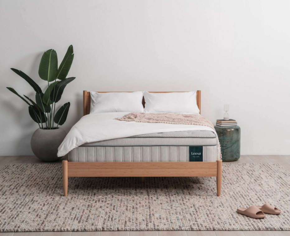 The Leesa Plus mattress on a wooden bedframe