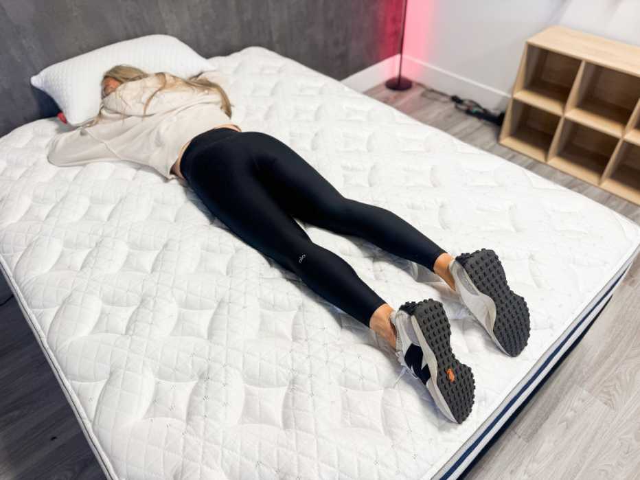 Woman lies on her stomach on a mattress