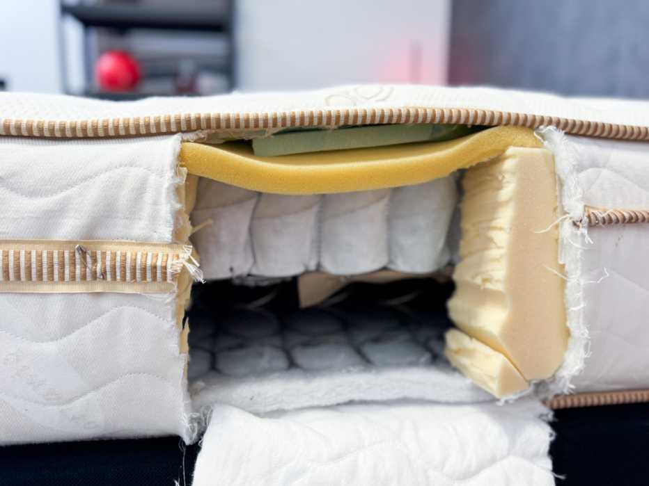 The Saatva Classic Luxury Firm is cut open to reveal layers of foam and durable coils
