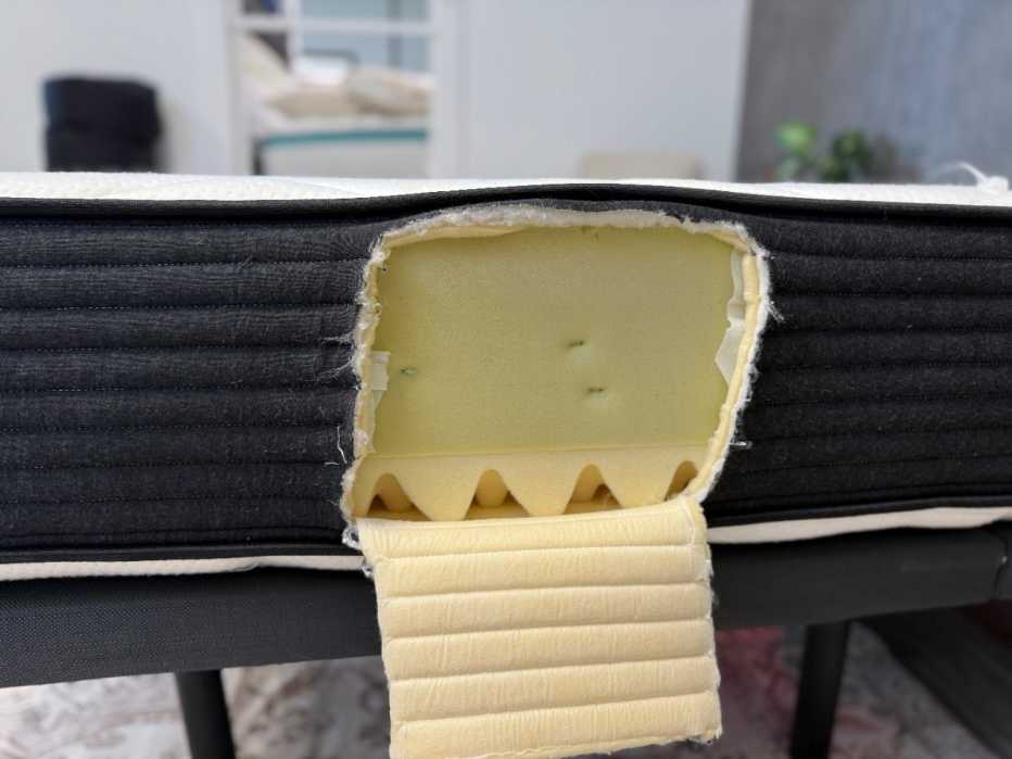 Plank Firm mattress is cut open to reveal the interior’s dense memory foam.