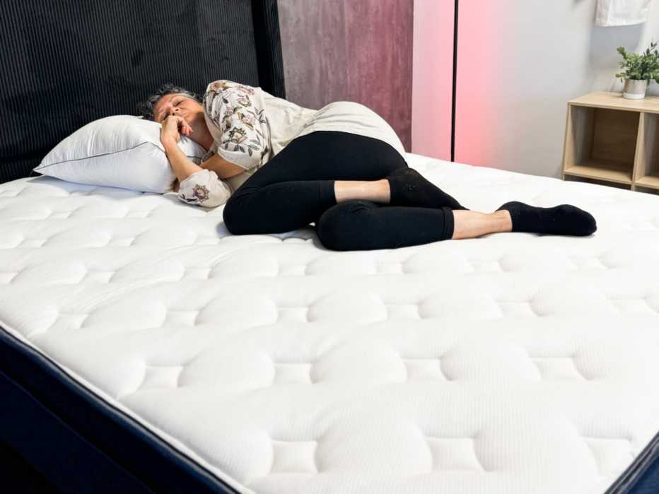 a person laying on a mattress