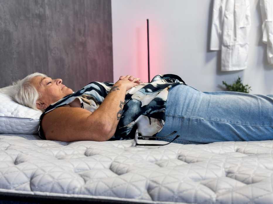 a woman laying on a mattress during a test