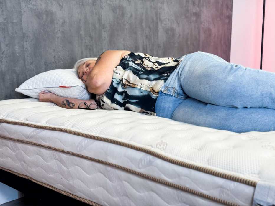 a woman laying on a mattress during a test