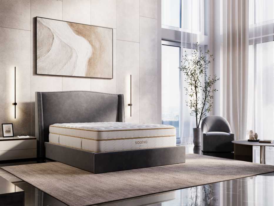 The Saatva Classic mattress in a bedroom with large windows.