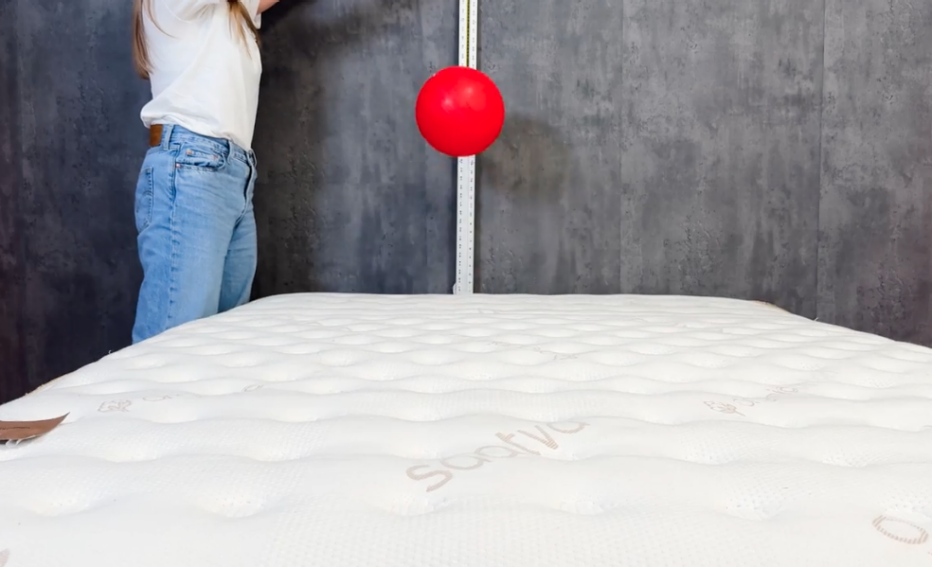 A lab tester dropping a 15-pound ball on the Saatva Classic mattress during our bounce test.
