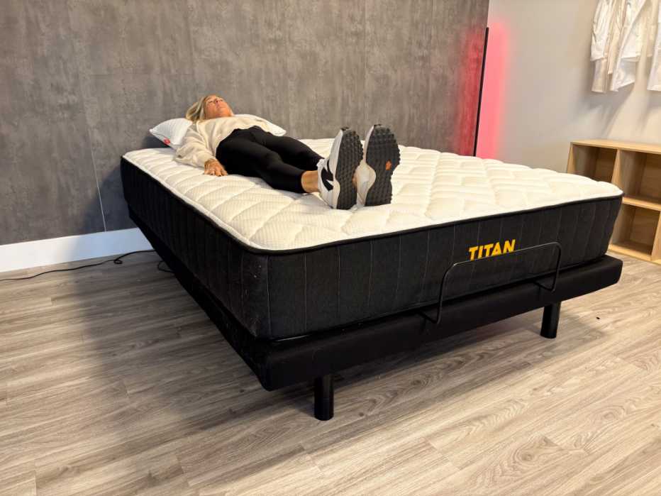A woman lying on her back on the Titan Plus Core mattress.