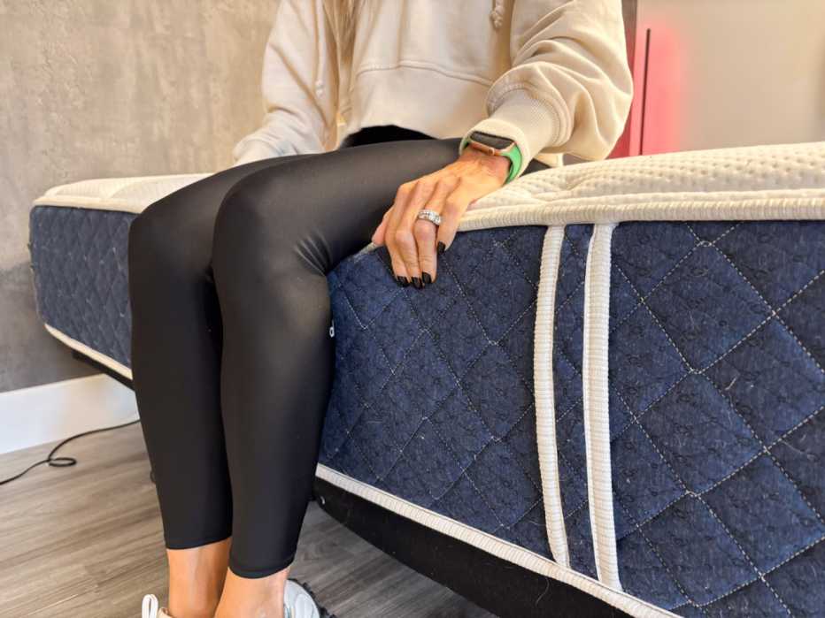 A woman sitting on the edge Brooklyn Bedding Signature mattress