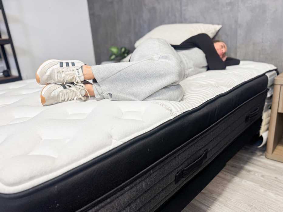 A woman lying on her side on the Nolah Evolution mattress
