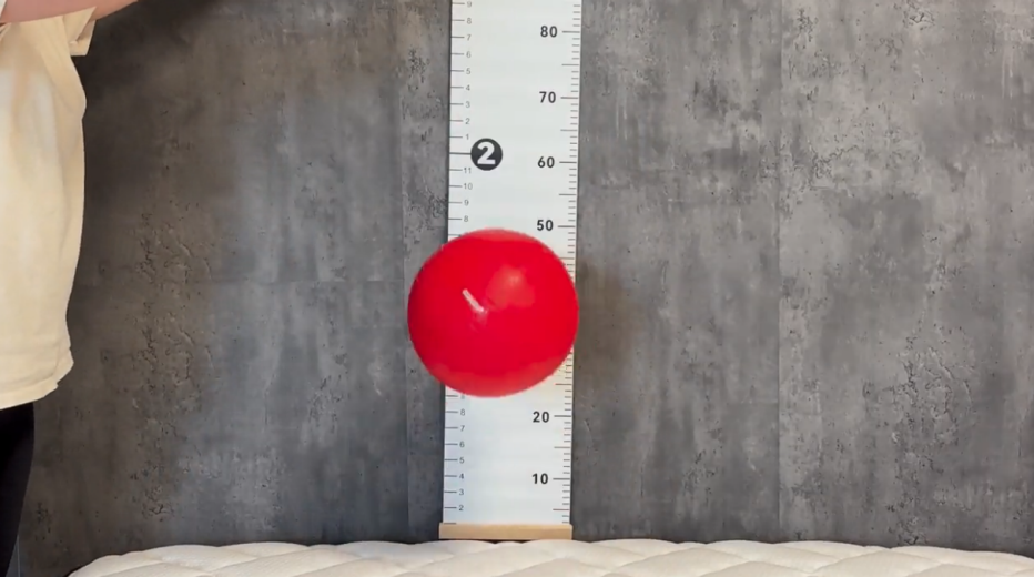 A 15-pound ball being dropped on the Titan Plus Core mattress during our bounce test
