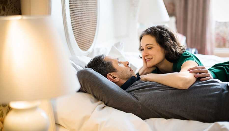 mature couple chatting on bed mature couple chatting on bed