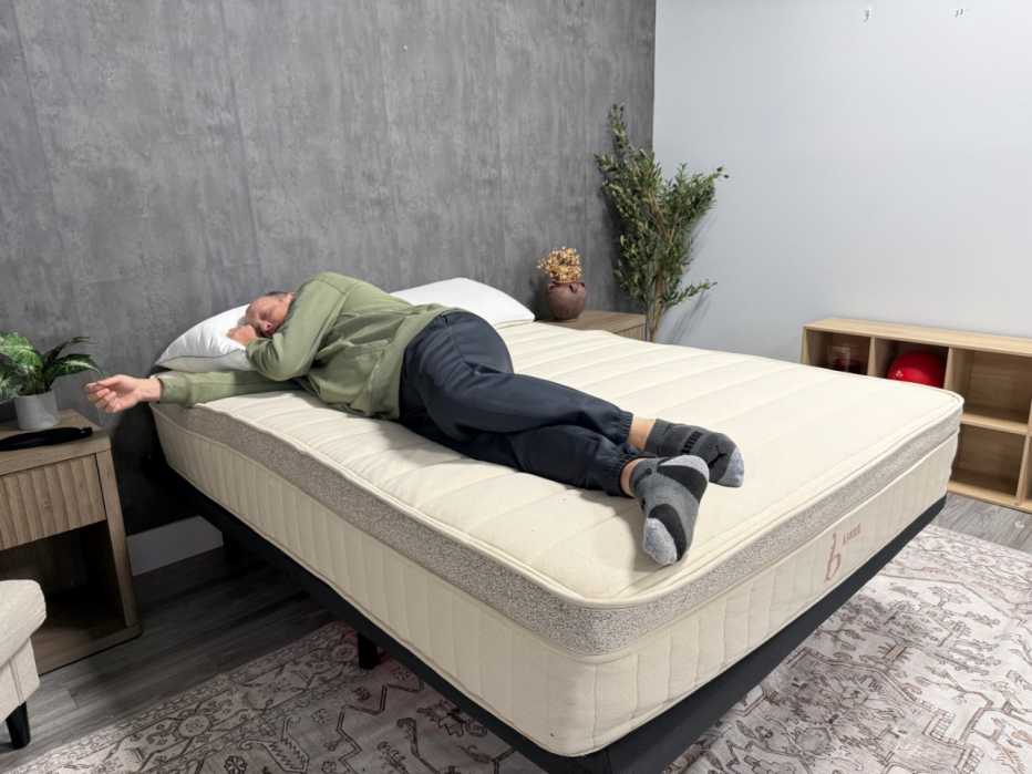Man lying on his side on a mattress 
