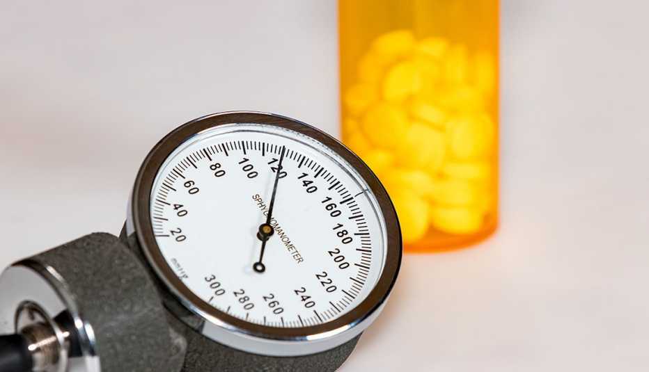 sphygmomanometer dial and bottle of pills sphygmomanometer dial and bottle of pills
