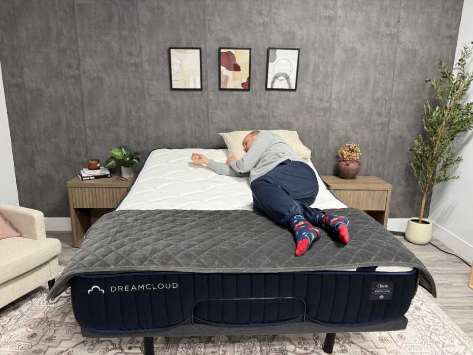 A man lying on his side on the DreamCloud Classic Memory Foam mattress
