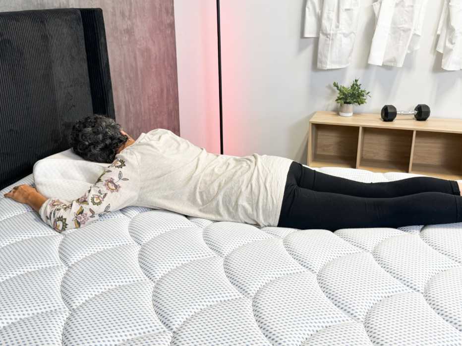 A woman lying on her stomach on the DreamCloud Premier mattress