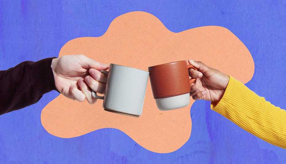 two hands clinking mugs together doing a cheers