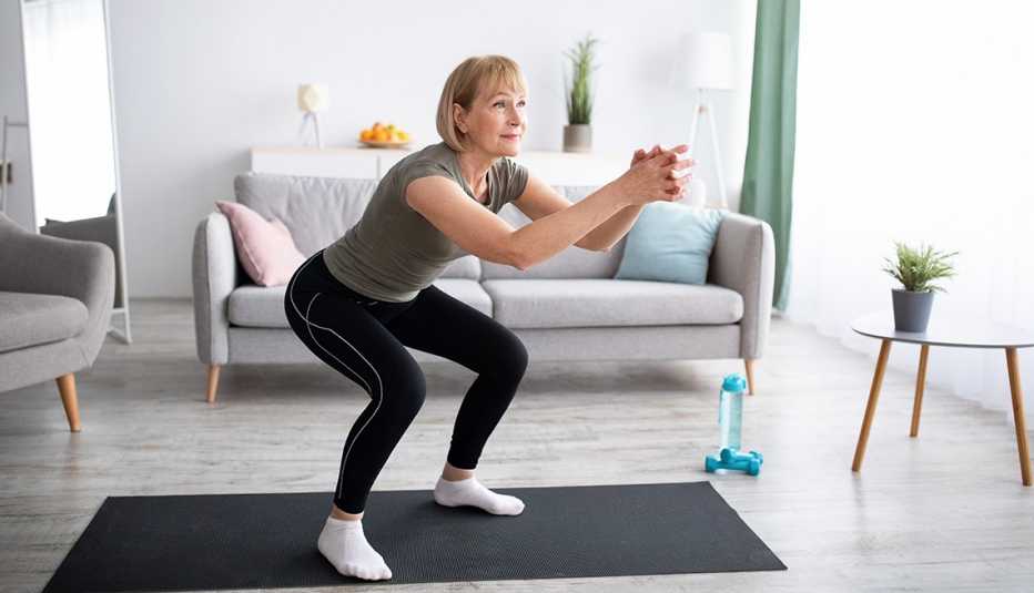woman doing squats at home