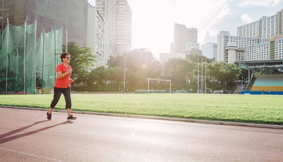 Mature Woman Listening to Music while Running, Coach Potato Syndrome, Healthy Living