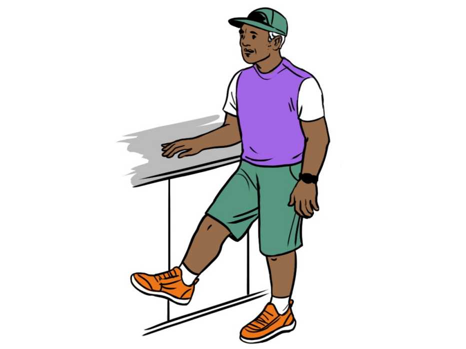 man standing with one hand supporting him on a counter and lifting one leg about six inches off the floor