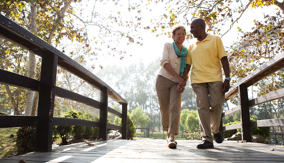 Mature couple walking through a prak 