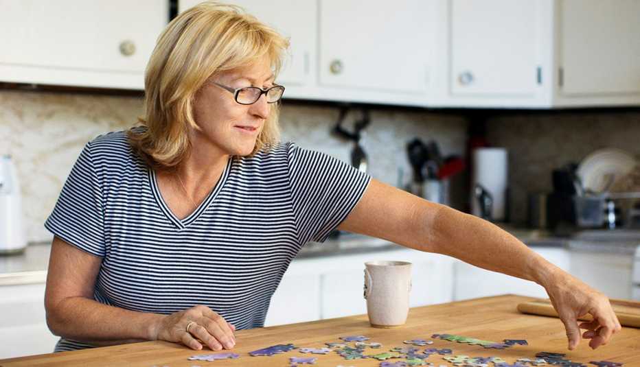 woman doing a puzzle in her kitchen