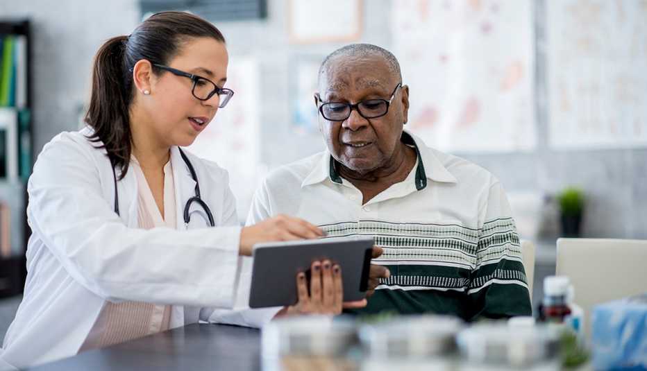 a man with his doctor looking at a tablet