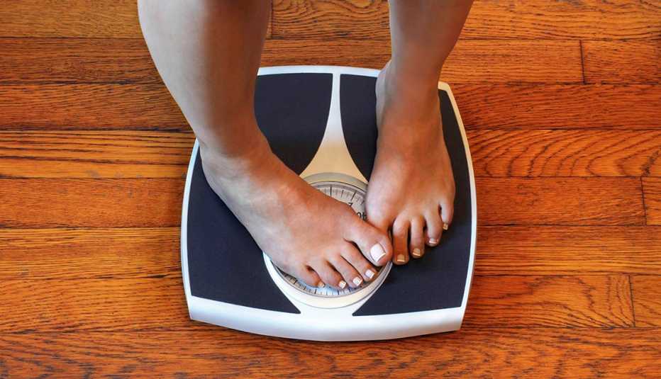 person standing on scale with their feet covering the reader so they cant see their weight person standing on scale with their feet covering the reader so they cant see their weight