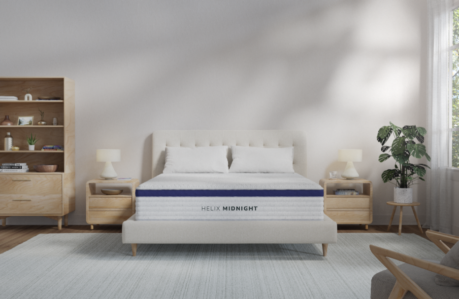 The Helix Midnight mattress in a bright bedroom with two wood nightstands.