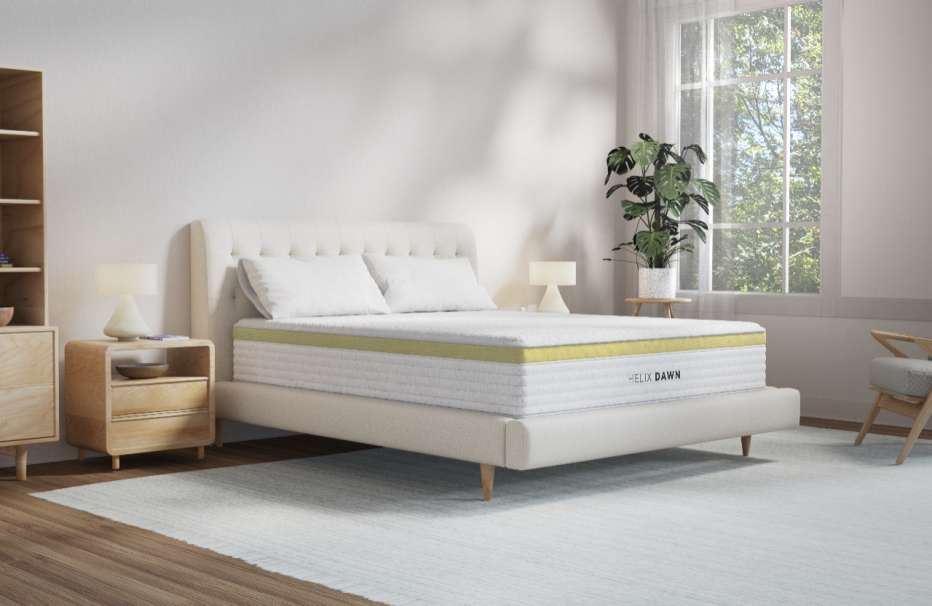 Helix Dawn mattress in a light bedroom with a plant in the corner.