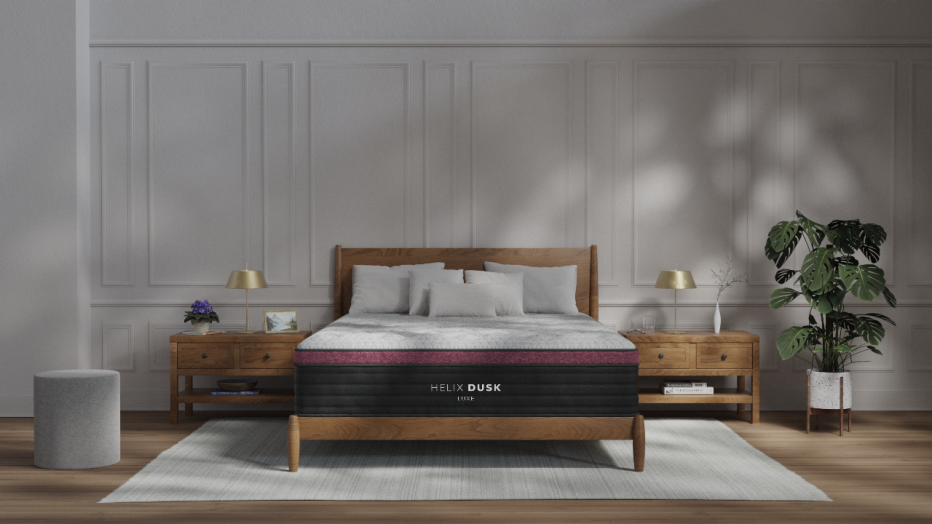 The Helix Midnight Luxe mattress in a bedroom with white walls.