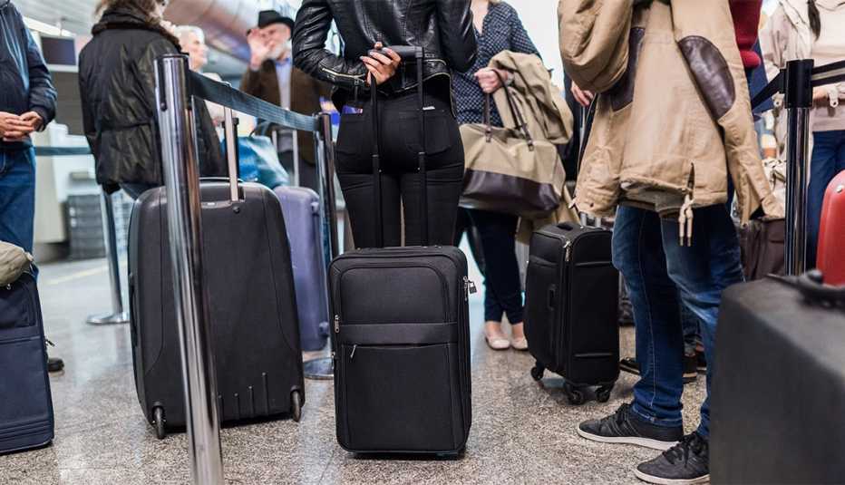 Group of people standing In queue at boarding gate