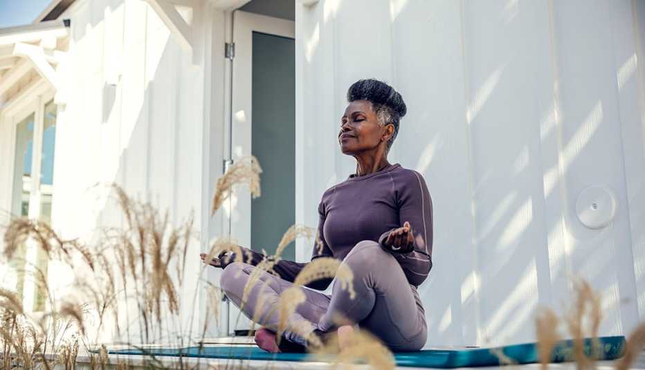 woman meditating in her backyard