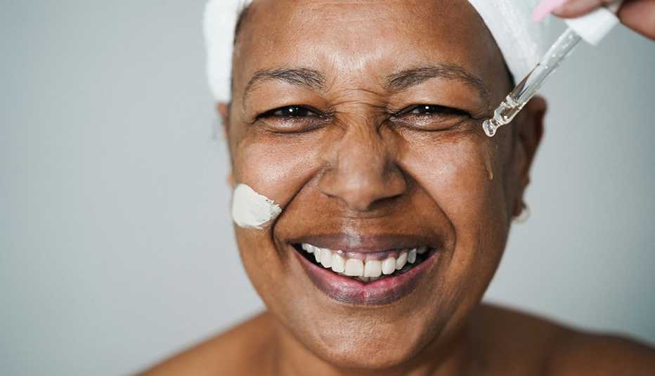 woman applying hyaluronic drop and skin mask beauty treatment on her face