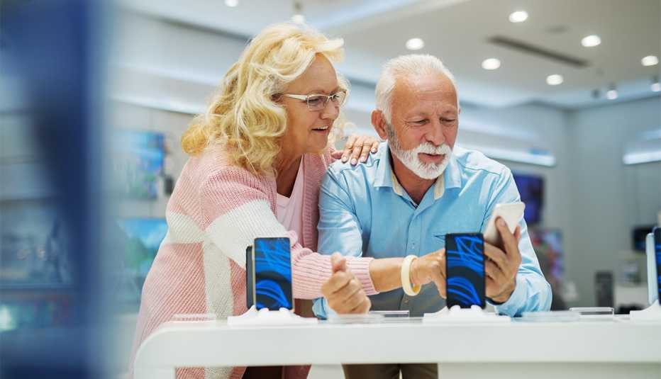 Couple testing out a smart phone at an electronics store