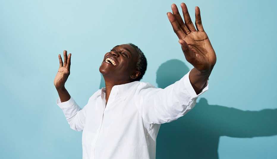 Joyful Woman Dancing on Blue Background
