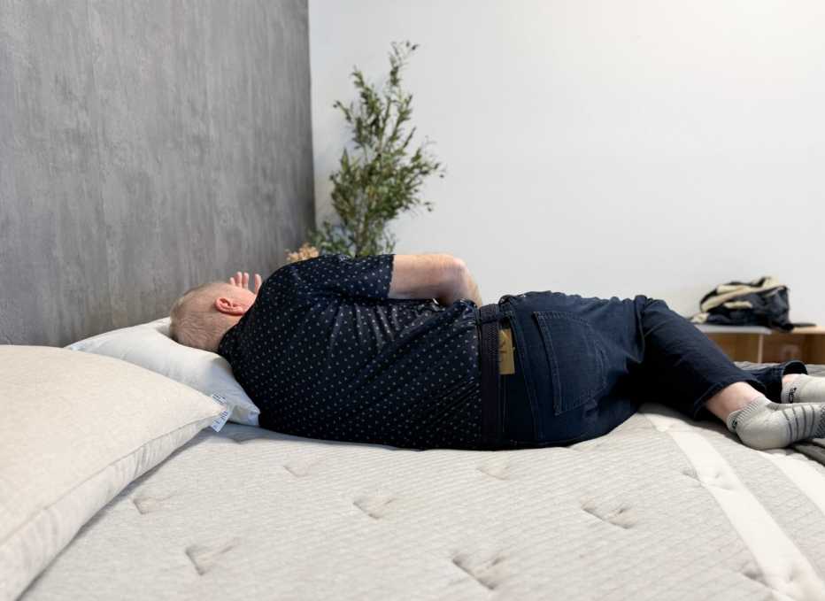 A man lying on his side on the Leesa Plus mattress