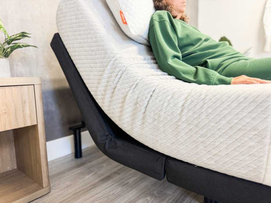 A woman lying on the Leesa Original mattress while it’s on an adjustable base.
