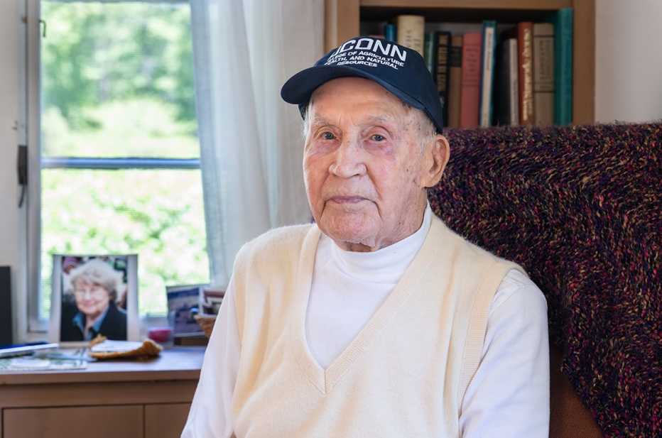 william aho age one hundred and five sits in a chair in his home
