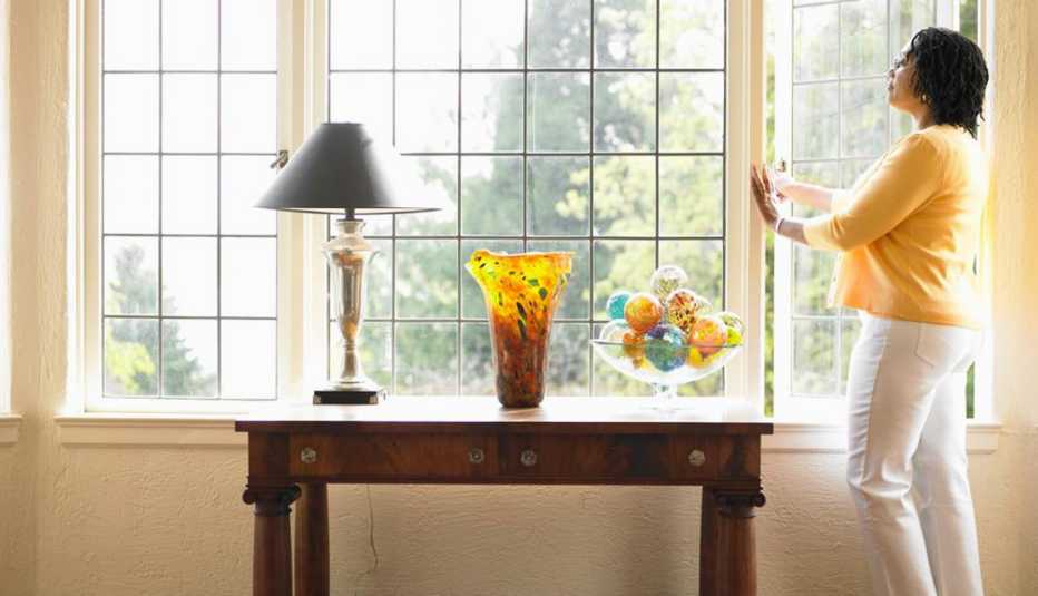 Woman opening Window in Living Room, Live Cleaner, Healthy Living