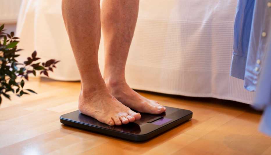 man standing on a weight scale