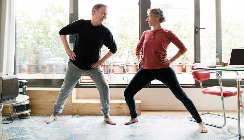 Man and woman taking an exercise break in a home office