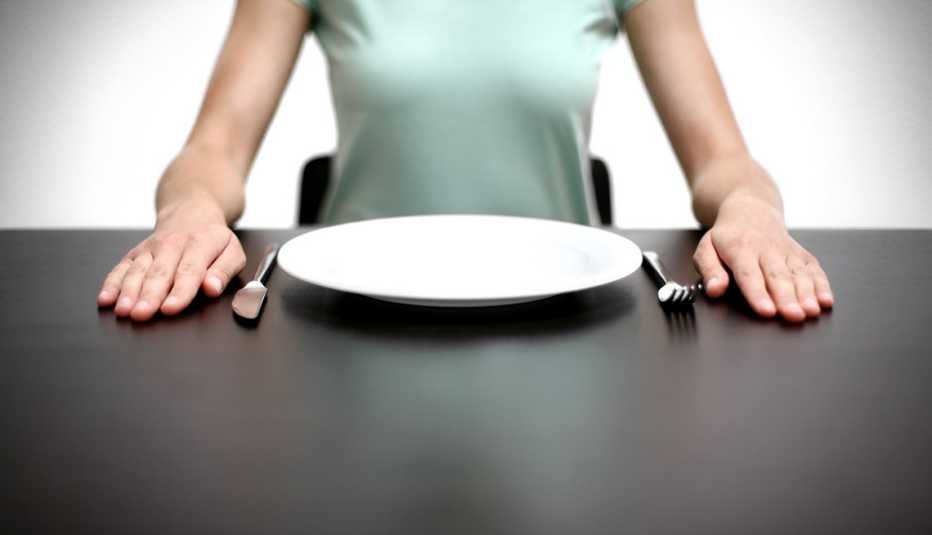 Woman sitting with empty plate