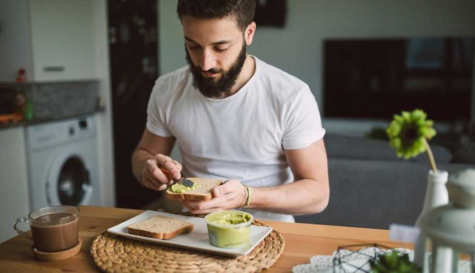 young person having avocado toast young person having avocado toast