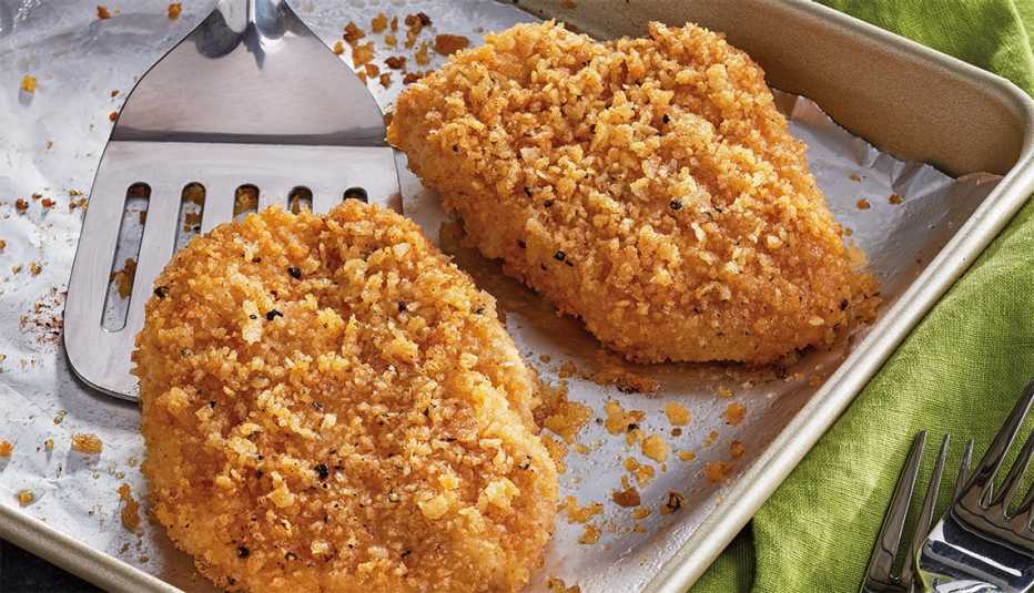 sheet pan out of the oven with freshly baked potato chip crusted chicken