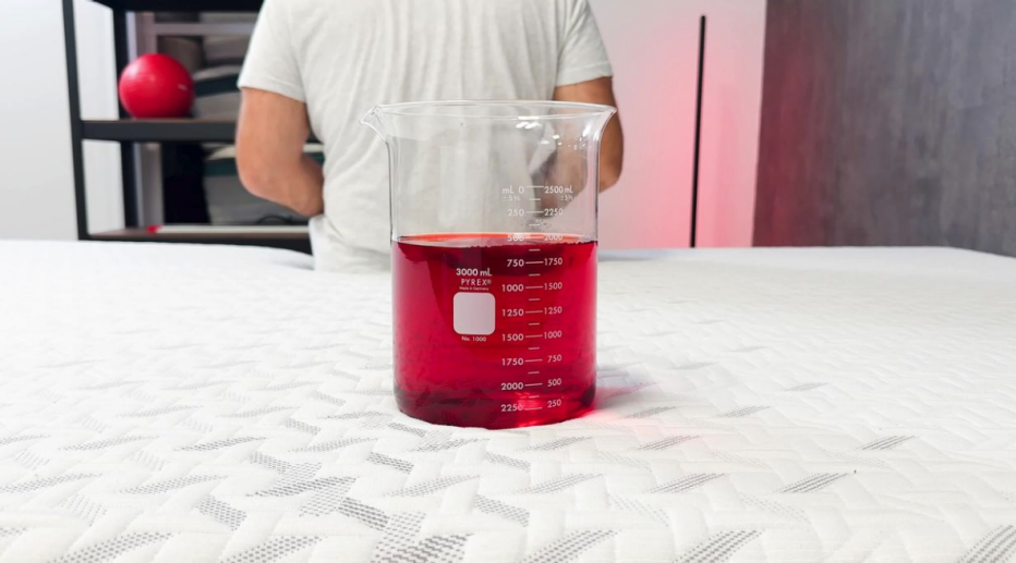 A glass of red liquid on the Nectar Classic Memory Foam mattress.