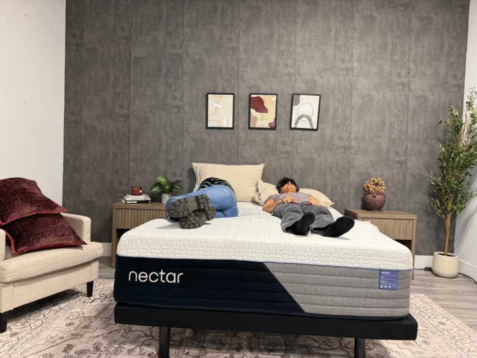 Two women lying on the Nectar Luxe Hybrid mattress. 