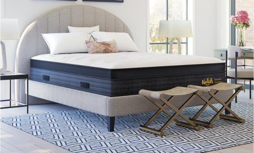 The Nolah Evolution Comfort Plus mattress in a bright room over a patterned rug