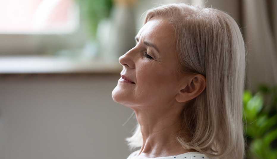 calm serene woman breathing with eyes closed 
