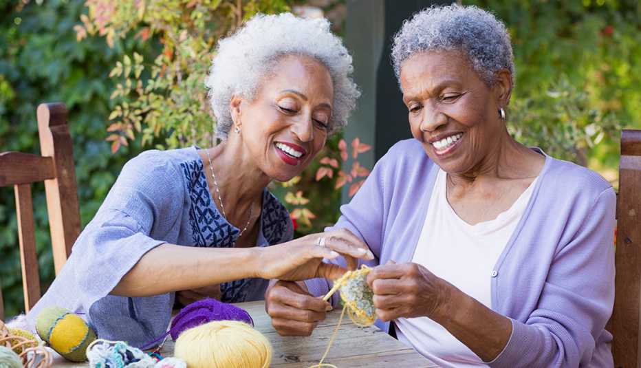 Two women knitting together